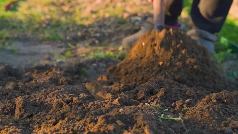 Man digging garden bed with shovel close-up 動画素材 341078931