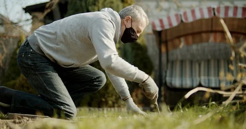 Man digging the ground to make a path from stones. Stock Footage 128321351