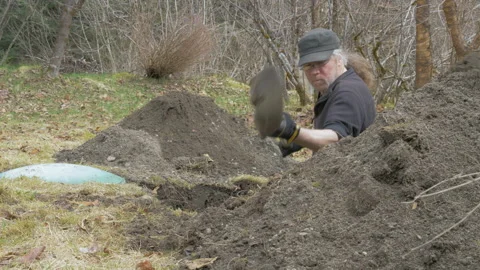 Man Digging Out Septic Tank in Yard Stock Footage 233246752