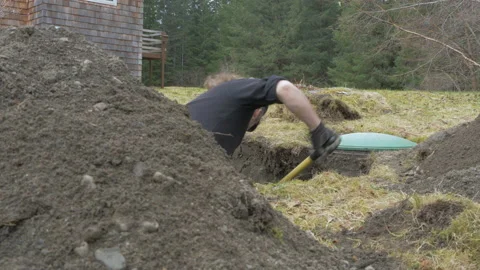 Man Digging Out Septic Tank in Yard Slide Right Stock Footage 233312877