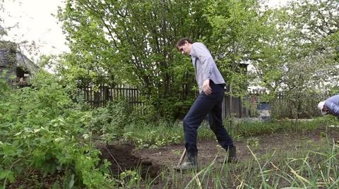Man digging shovel in the garden Stock Footage 63063154