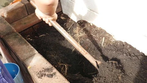 A man digging soil for planting organic vegetables Stock Footage 72972056
