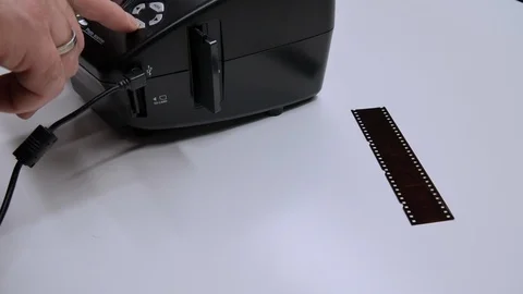 A man digitizes a camera film on a device Vidéo 99710182
