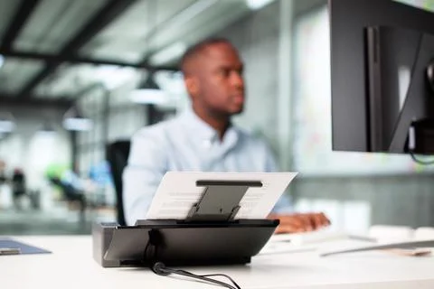 Man Digitizing Paper Documents Using Scanner In Office Profession: Accountant Foto stock