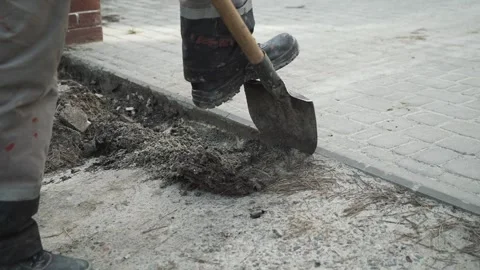 Man digs a ditch in the ground with a shovel Stock Footage 266806437