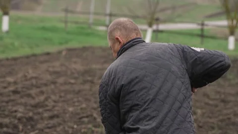 A man digs a garden with a shovel Stock Footage 259871653