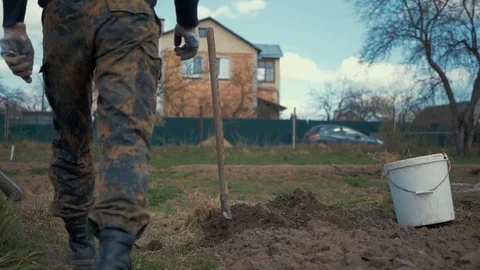 A man digs the ground with a shovel Stock Footage 89235983