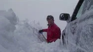 A Man Digs His Car Out Of A Snowstorm In Winter. Stock Footage