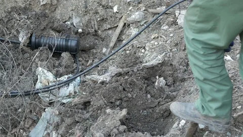 Man digs optic cable connection Stock Footage 70203483