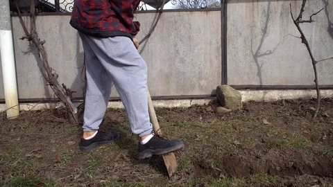 The man digs a trench, the man digs the ground with a shovel Stock Footage 125809561