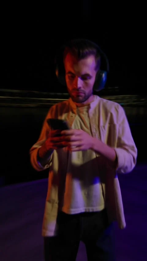 A man in a dim room explores virtual reality, blending tech with life Stock Footage 317844219