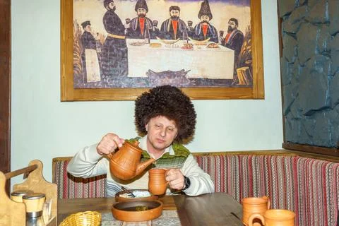 A man is dining alone in an elegant restaurant Stock Photos