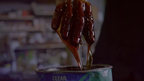 Man dipping his hand in varnish indoors Stock Footage 279774853