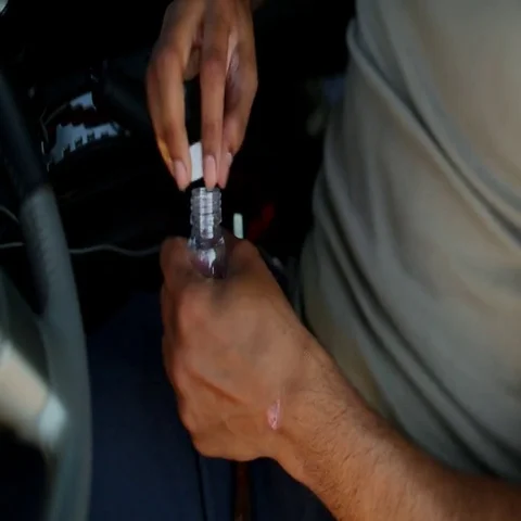 Man dipping midwakh in bottle. Stock Footage 69481240