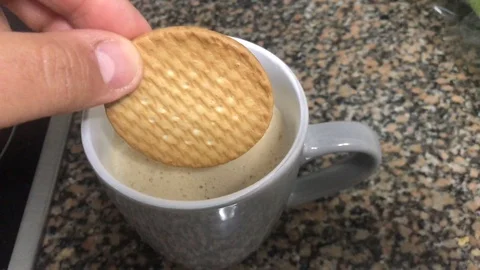 Man dips cookies in cafe for quick breakfast before going to work Stock Footage 126627157