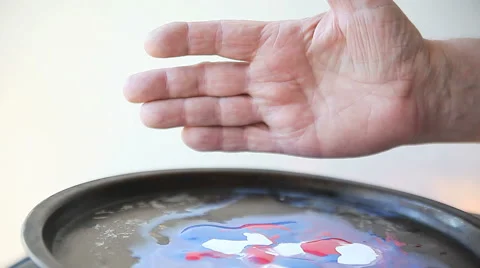 Man dips hand in paints Stock Footage 47784852