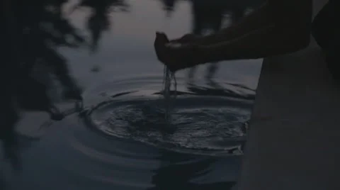 Man dips hands in swimmingpool Stock Footage 57360810