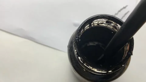 A man dips a pen into a jar of ink. Stock Footage 228878844