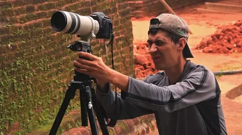 Man directs a lens at sharpness before video shooting Stock Footage 21895609