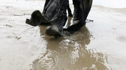 Man in dirty black boots, walking through the mud - slow motion Stock Footage 67455270