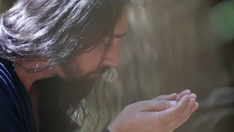 Man in dirty dark clothes  drinks Vídeo Stock 232851034