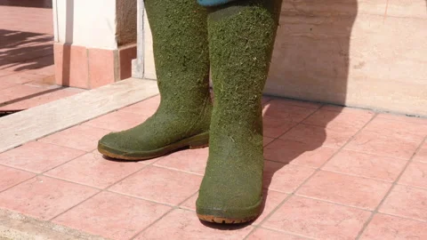 Man in dirty rubber boots for working in countryside, gardening concept Stock Footage 155804128
