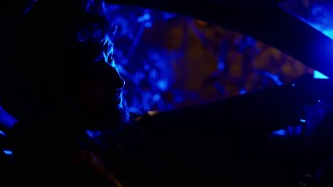 Man at the dirvers seat looks at camera and laugh under police lights Stock Footage 156528232