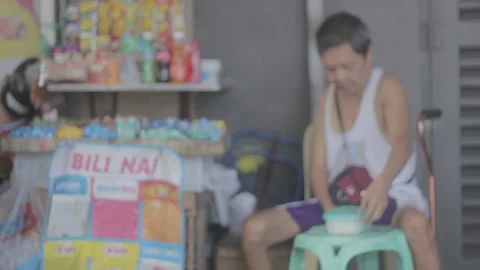 A man with disability eating while watching his store Stock Footage 230089156