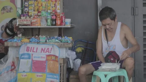 A man with disability eating while watching his store Stock Footage 230089232