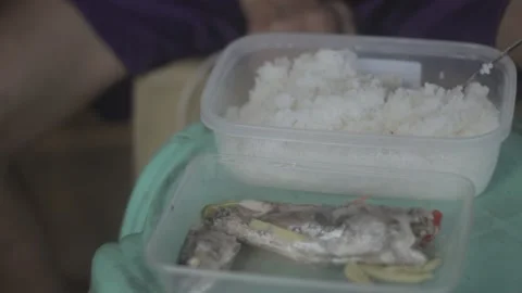 A man with disability eating while watching his store Stock Footage 230089237
