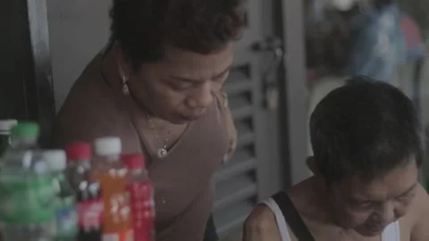 A man with disability eating while watching his store Stock Footage 230089286
