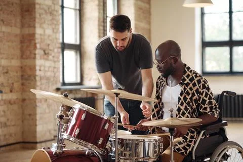 Man with disability learning to play drums Stock Photos