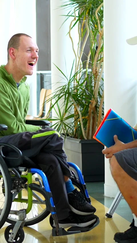 Man with disability talking with university colleague in the corridor Stock Footage 276457760