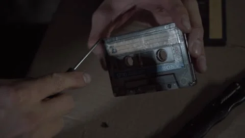 The man disassembles the audio tape, unscrews the bolts Stock Footage 131564517