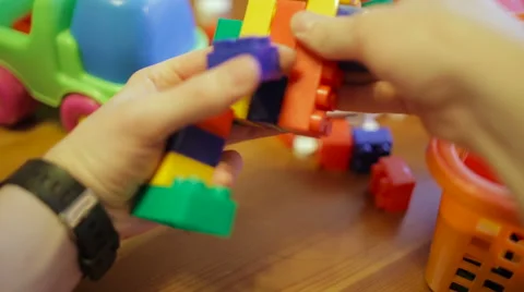 Man disassembles figure made from children's toy blocks, first-person view Video stock 61380830