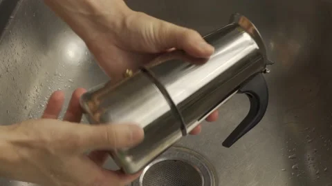 Man disassembles Geyser coffee maker to wash it. His hands are shown in close-up Stock Footage 233019884