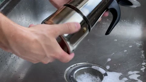 Man disassembles Geyser coffee maker to wash it. His hands are shown in close-up Video stock 233463762