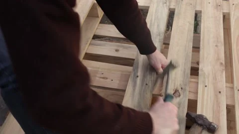 A man disassembles a pallet Stock Footage 152232303
