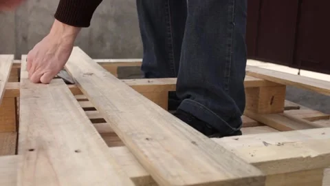 A man disassembles a pallet Stock Footage 152232351