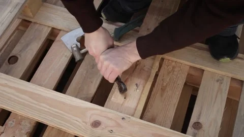 A man disassembles a pallet Stock Footage 152232412