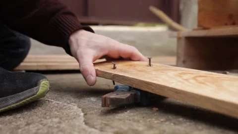 A man disassembles a pallet Stock Footage 152232575