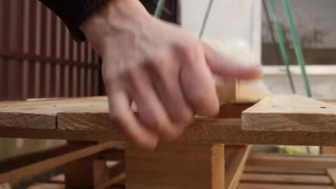 A man disassembles a pallet Stock Footage 152232633