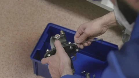 Man disassembles the production part on the components, unscrews the screws Stock Footage 147254997