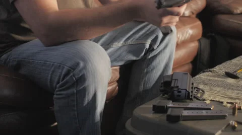 Man Disassembling and Cleaning .45 Caliber Semi-Automatic Gun Stock Footage 60665228