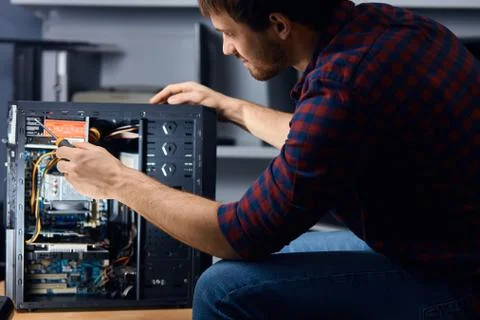 Man disassembling and reassemblin the computer Stock Photos