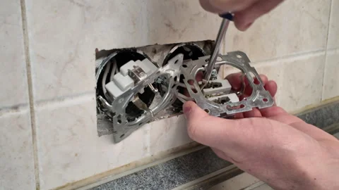 Man disassembling a wall socket for replacement Stock Footage 312603052