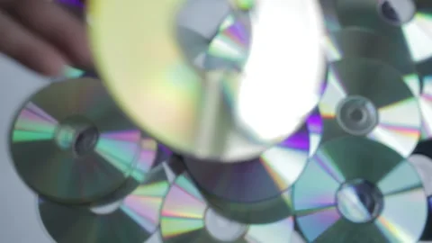 A man discards many CDs and DVDs that are not useful anymore due to scratches an Stock Footage 167430933
