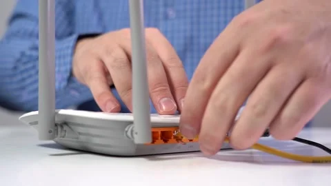 Man Disconnects Lan Cable from Router. Router Wireless. Close-up Stock Footage 156349338