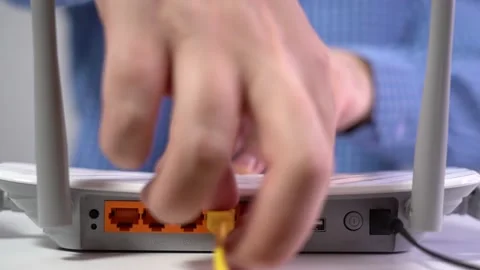 Man Disconnects Lan Cable from Router. Router Wireless. Close-up Stock Footage 166514692