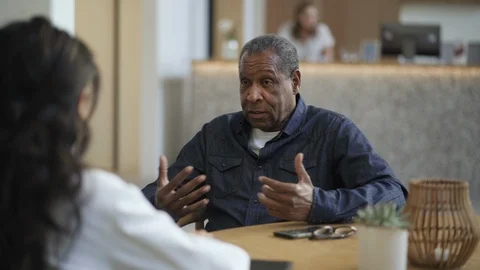 Man discussing his problems with physician in hospital Stock Footage 105600088
